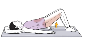 Woman lying on floor with knees bent and feet flat on floor, raising hips off floor to do bridge exercise.