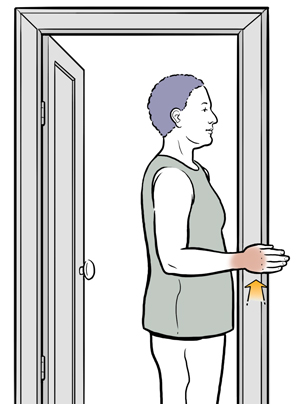 Woman standing in door frame doing internal rotation shoulder exercise.