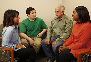 Group of two men and two women talking together.